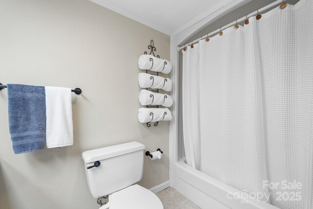 bathroom featuring tile patterned flooring, toilet, and shower / bath combo with shower curtain