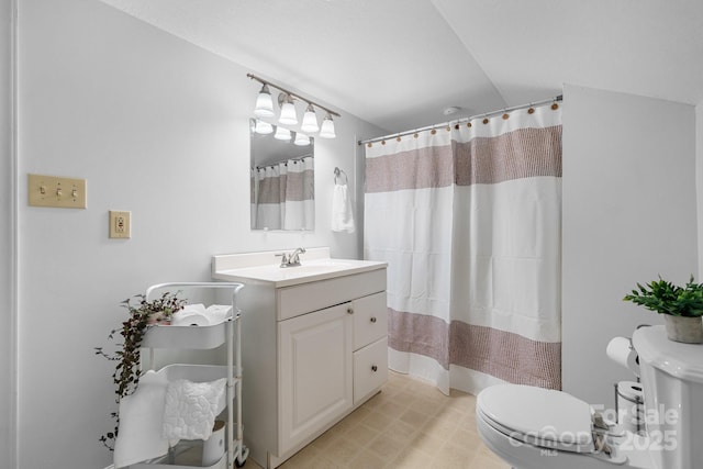 bathroom featuring vanity, a shower with shower curtain, and toilet