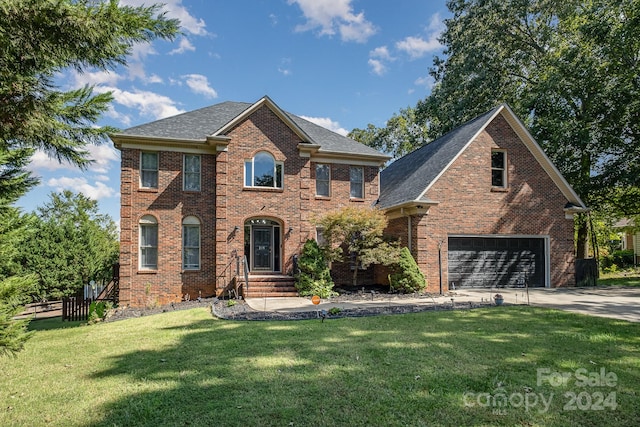 view of front of property with a front yard and a garage