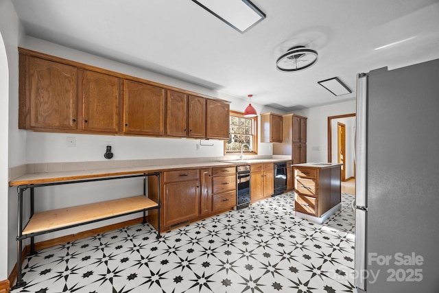 kitchen featuring sink and stainless steel fridge