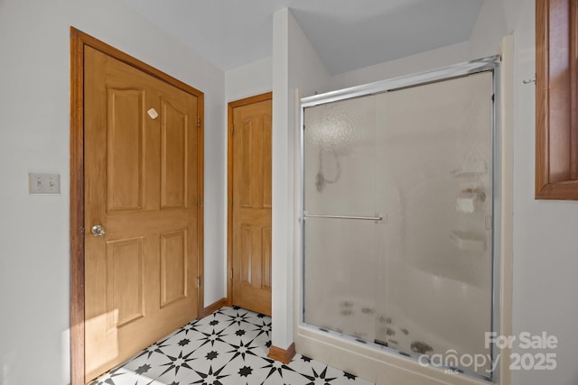 bathroom with a shower with door