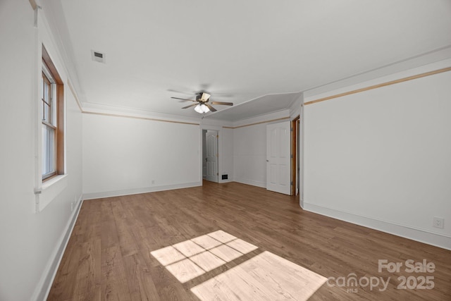 empty room with ceiling fan, ornamental molding, and light hardwood / wood-style floors