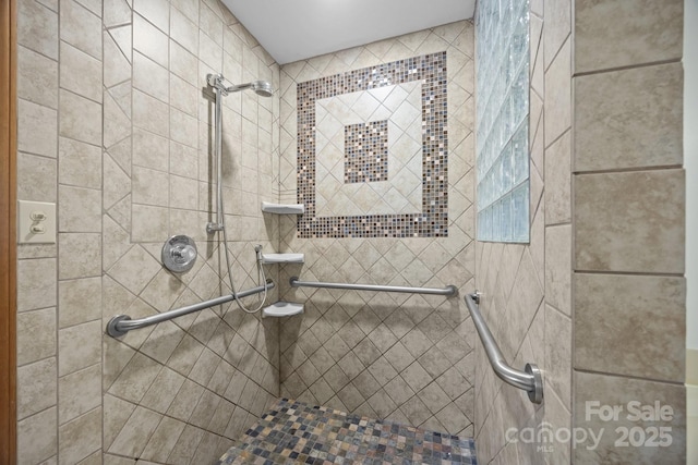 bathroom with a tile shower