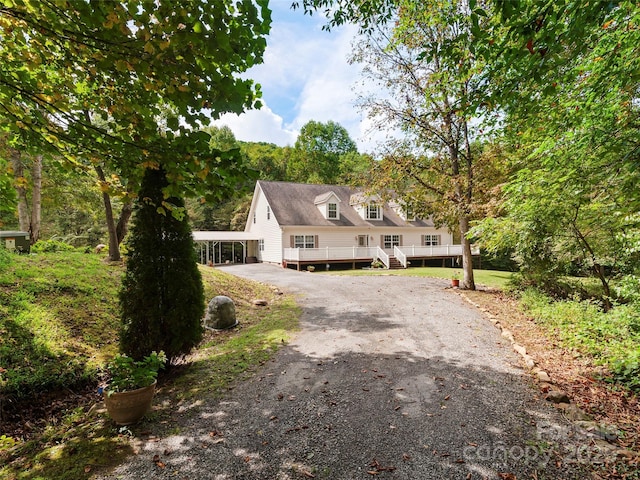 cape cod home featuring a wooden deck