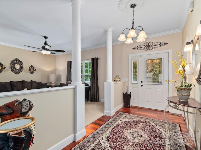 entrance foyer with wood-type flooring, ceiling fan with notable chandelier, decorative columns, and crown molding