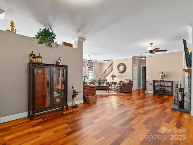 living room with hardwood / wood-style floors and ornamental molding