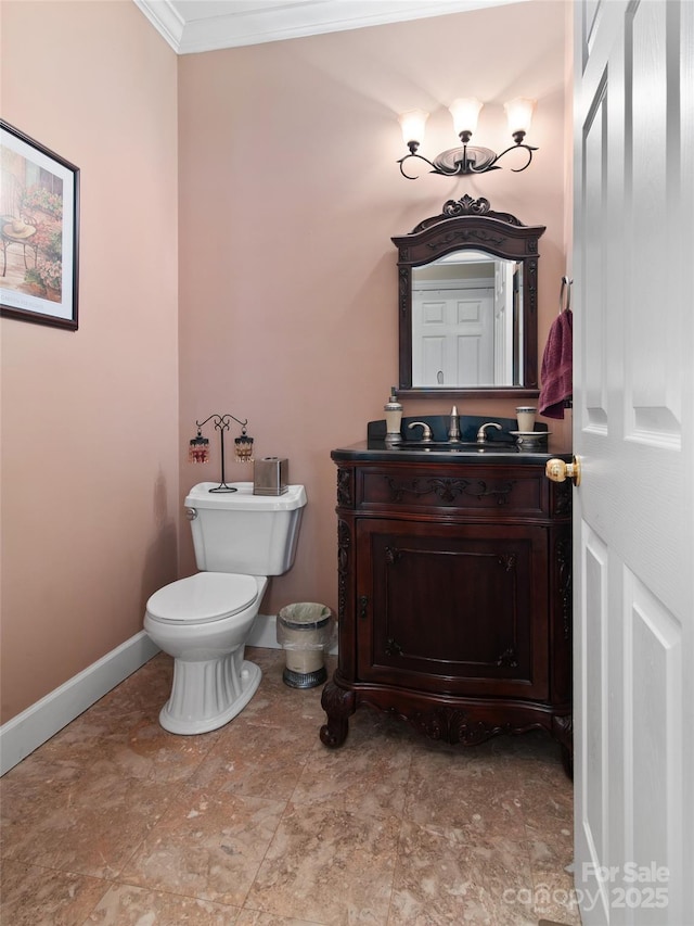 bathroom featuring crown molding, vanity, and toilet