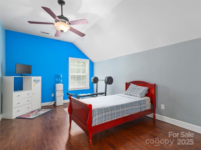 bedroom featuring ceiling fan, dark hardwood / wood-style flooring, and vaulted ceiling