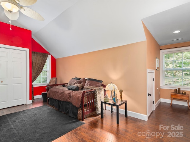 bedroom with dark hardwood / wood-style flooring, a closet, vaulted ceiling, and ceiling fan