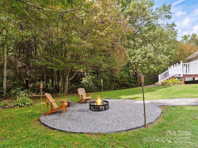 view of yard with a fire pit and a deck