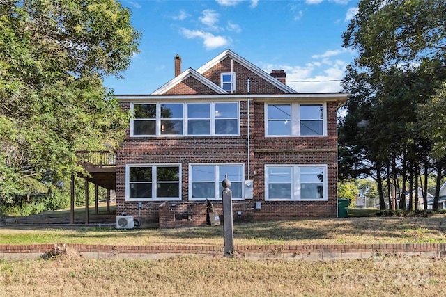 view of front of property featuring a front lawn and ac unit