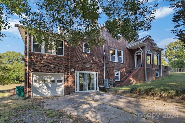 view of front of property featuring central AC and a garage