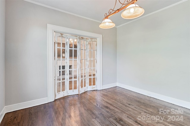 unfurnished dining area featuring dark hardwood / wood-style floors and crown molding