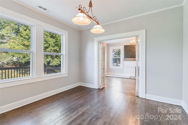 unfurnished dining area with ornamental molding and dark hardwood / wood-style floors