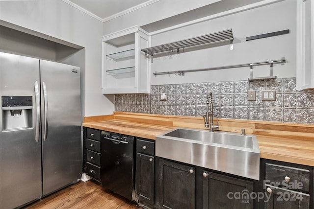 kitchen with backsplash, black dishwasher, stainless steel fridge, and wooden counters