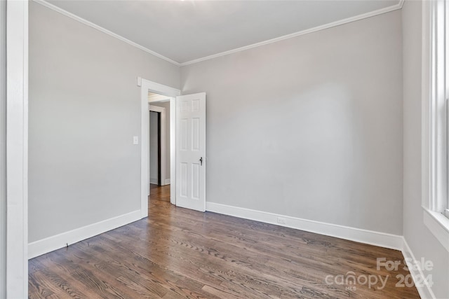 unfurnished room featuring dark hardwood / wood-style floors and crown molding