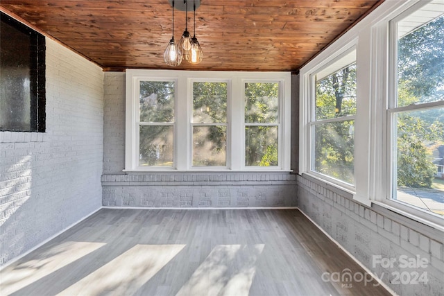 unfurnished sunroom with wood ceiling and a notable chandelier