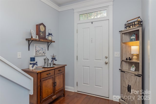 foyer featuring dark hardwood / wood-style floors and crown molding