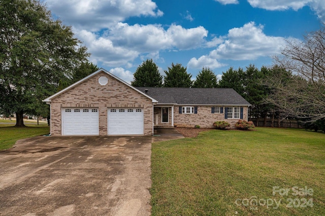 single story home with a garage and a front lawn