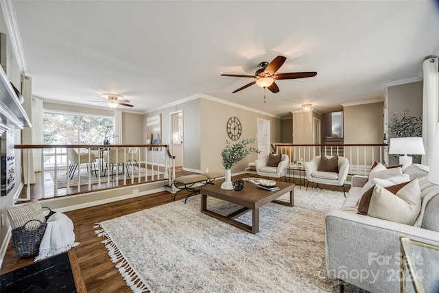 living room featuring ceiling fan, ornamental molding, and dark hardwood / wood-style floors