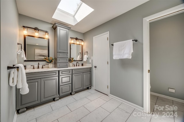 bathroom with vanity, toilet, and a skylight