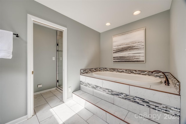 bathroom featuring plus walk in shower and tile patterned floors