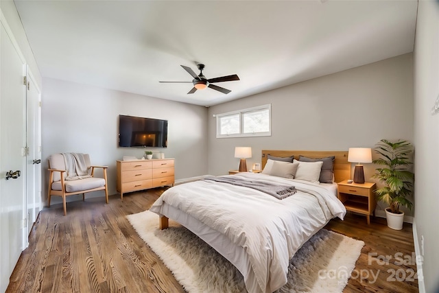 bedroom featuring dark hardwood / wood-style floors and ceiling fan