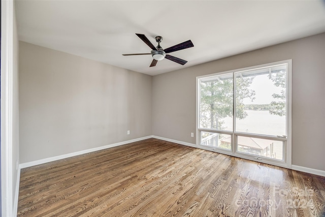 empty room with ceiling fan and hardwood / wood-style flooring