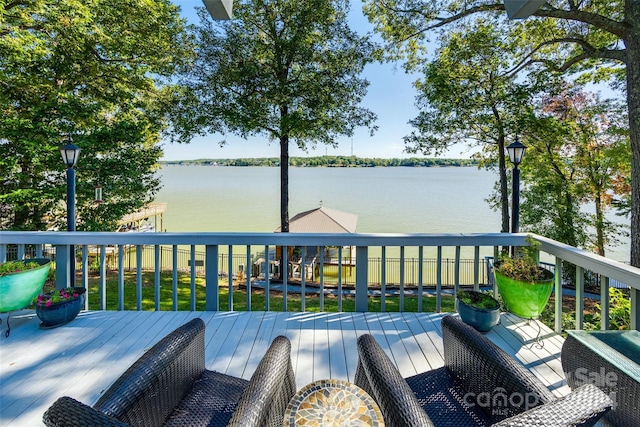 wooden deck featuring a yard and a water view