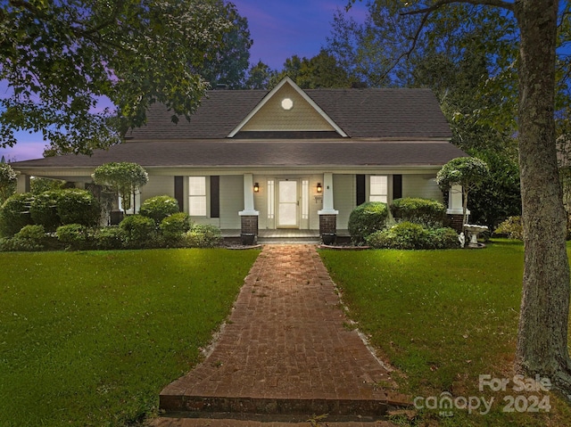 view of front of home with a lawn and covered porch