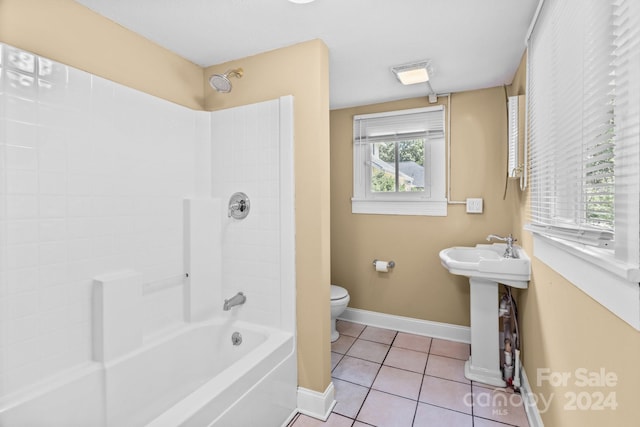 bathroom with tile patterned flooring, shower / tub combination, and toilet