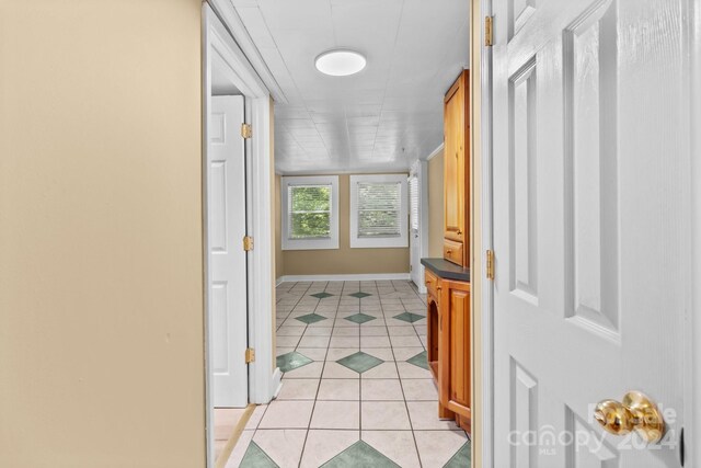 hallway with light tile patterned floors