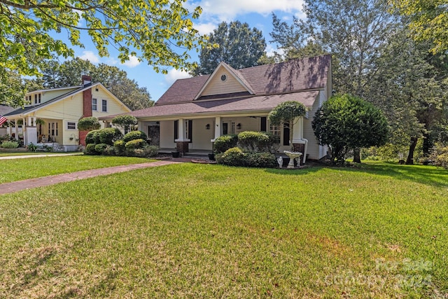 view of front of home with covered porch and a front yard