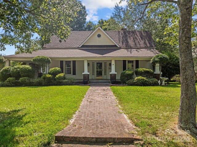 view of front facade with a front lawn and covered porch