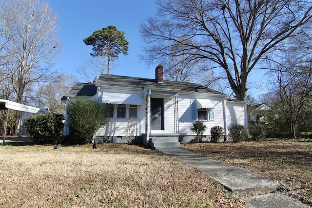 bungalow-style home featuring a front yard