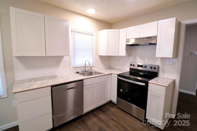 kitchen featuring stainless steel appliances, dark wood-type flooring, white cabinets, and sink