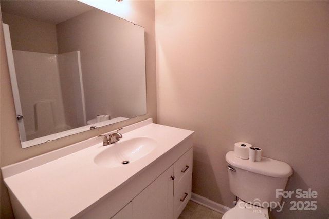 bathroom featuring walk in shower, vanity, and toilet