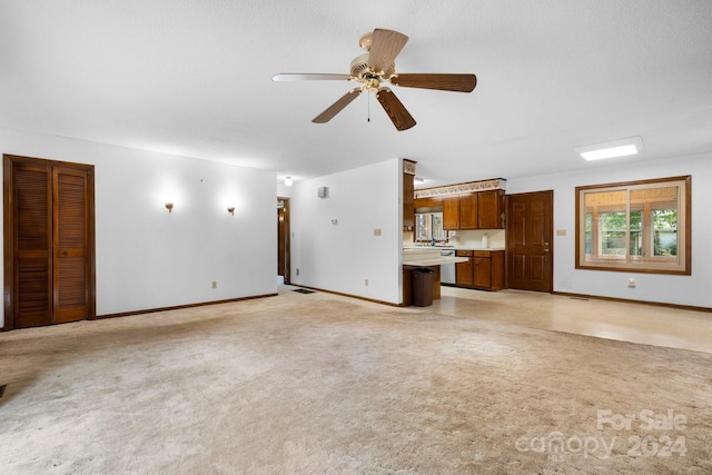 unfurnished living room featuring a textured ceiling and ceiling fan