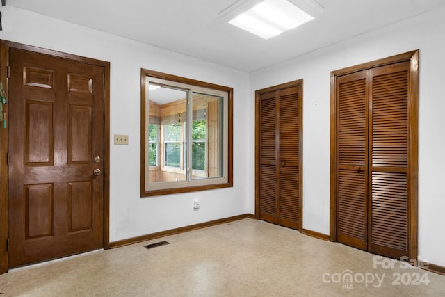 unfurnished bedroom with multiple closets