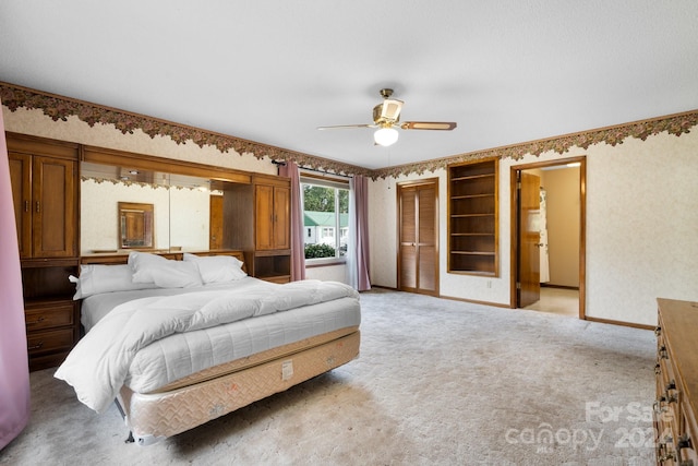 carpeted bedroom featuring a closet and ceiling fan