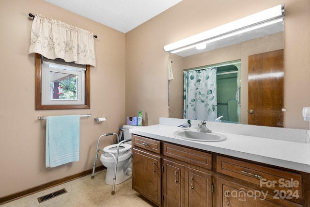 bathroom featuring vanity, a shower with curtain, and toilet