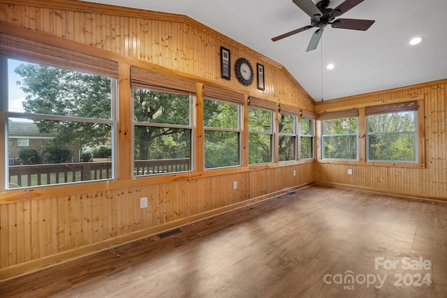 unfurnished sunroom with ceiling fan and vaulted ceiling