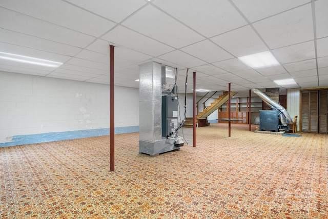 basement with a paneled ceiling