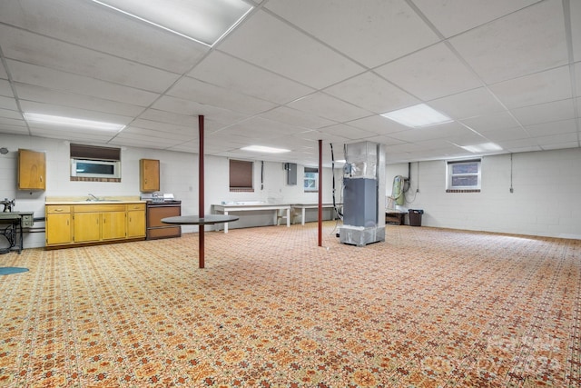 basement featuring sink and a drop ceiling