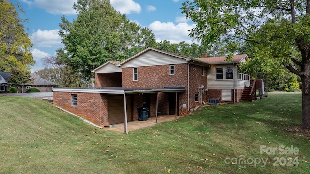 rear view of house with a patio area and a lawn