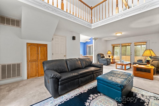 living room with carpet floors and a high ceiling