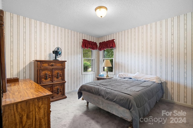 carpeted bedroom featuring a textured ceiling