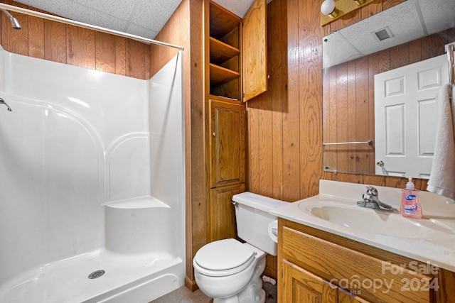 bathroom with vanity, toilet, walk in shower, and wooden walls