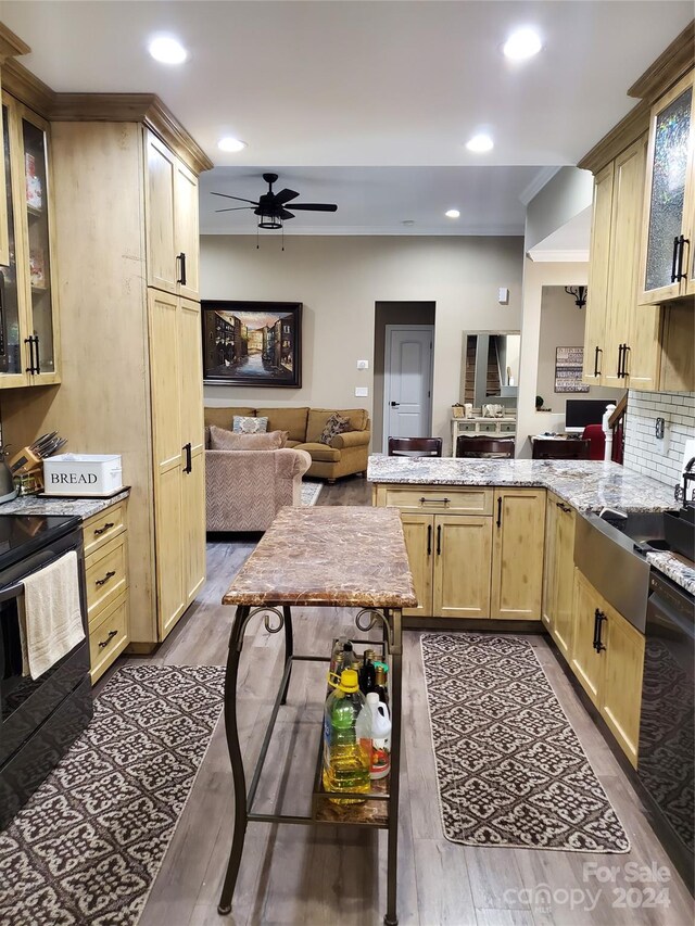 kitchen featuring ceiling fan, light brown cabinets, hardwood / wood-style flooring, and black electric range oven