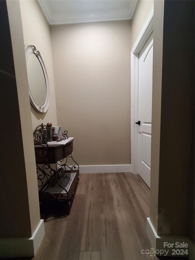 hall featuring crown molding and hardwood / wood-style floors